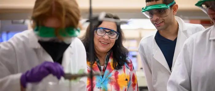 Carnegie Mellon students working with their professor in a tie dye lab.